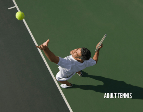 Tennis student serving on an outdoor court during an adult tennis lesson hosted by Lifetime Activities at the Goldman Tennis Center in San Francisco.