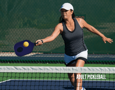 Pickleball student hitting a ball on an outdoor court during an adult pickleball lesson through Lifetime Activities.