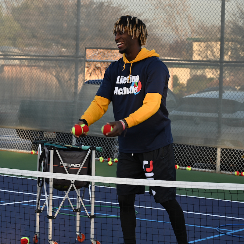 A Lifetime Activities Coach on the tennis court.