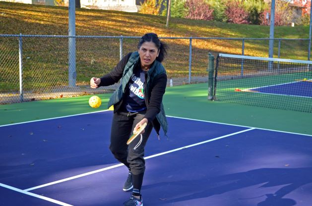 Lifetime Activities employee coaching pickleball.